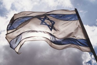 israeli flag flying with sun coming through it