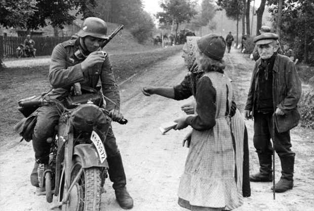 A German soldier with civilians in September 1939 during the German invasion of Poland