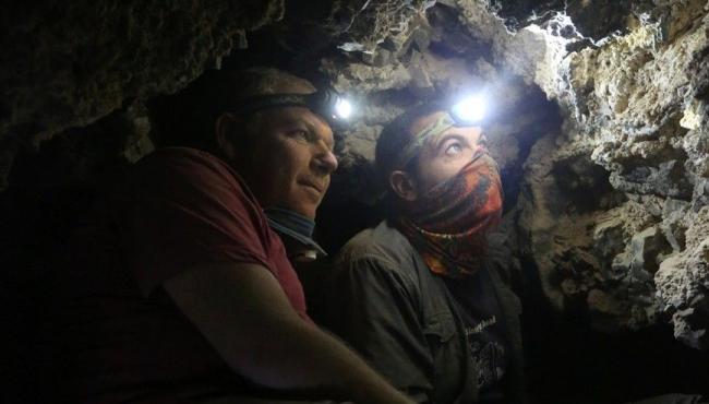 archaelogists surveying the cave