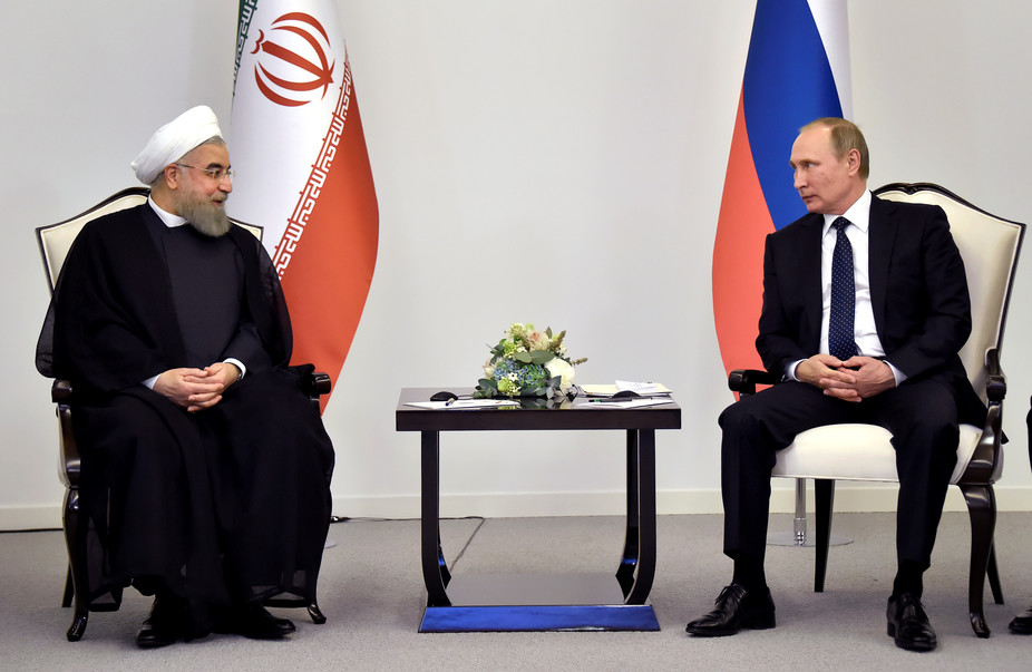 Iranian President Hassan Rouhani talks to Russian President Vladimir Putin during a meeting in Baku, Azerbaijan on August 8 2016.