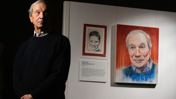 Dr Paul Valent with portraits of himself as a child and an adult