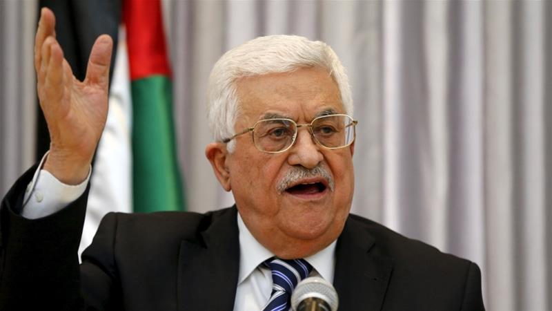 Abbas speaking at a microphone, close up