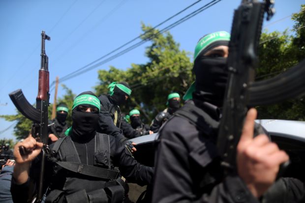 masked hamas members with guns close up at a rally