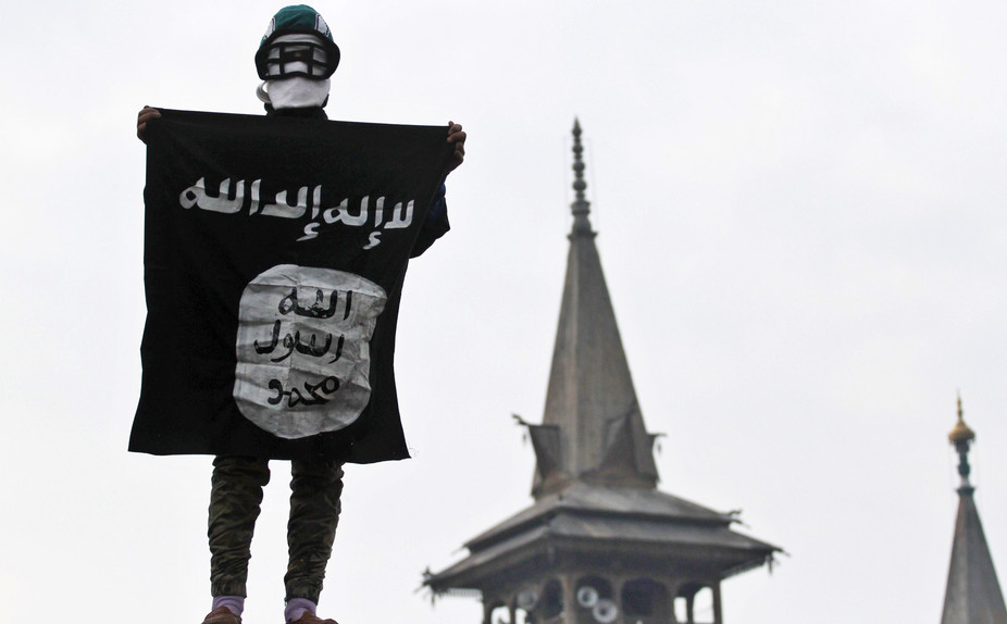lone person standing holding a terror sign with their face covered