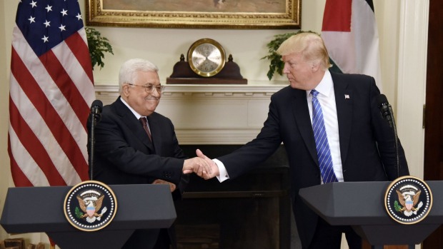 Trump and Abbas shaking hands at the podium
