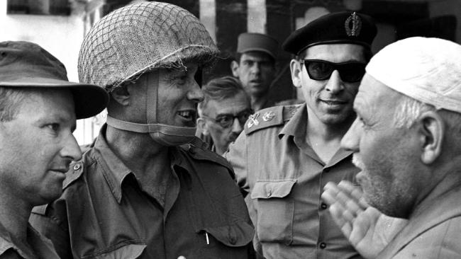 Moshe Dayan in conversation with others