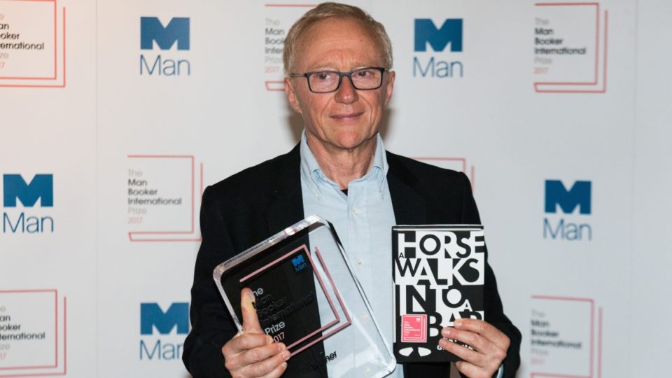 David Grossman holding his book and his award