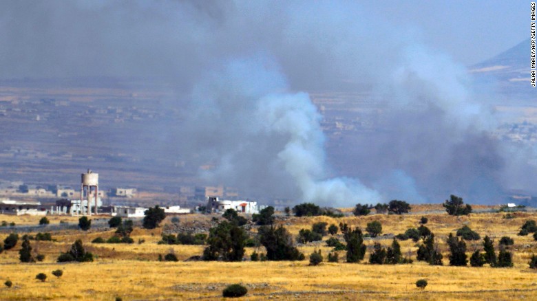smoke billowing in distant Syria