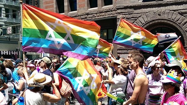 the jewish pride flag being waved at a rally
