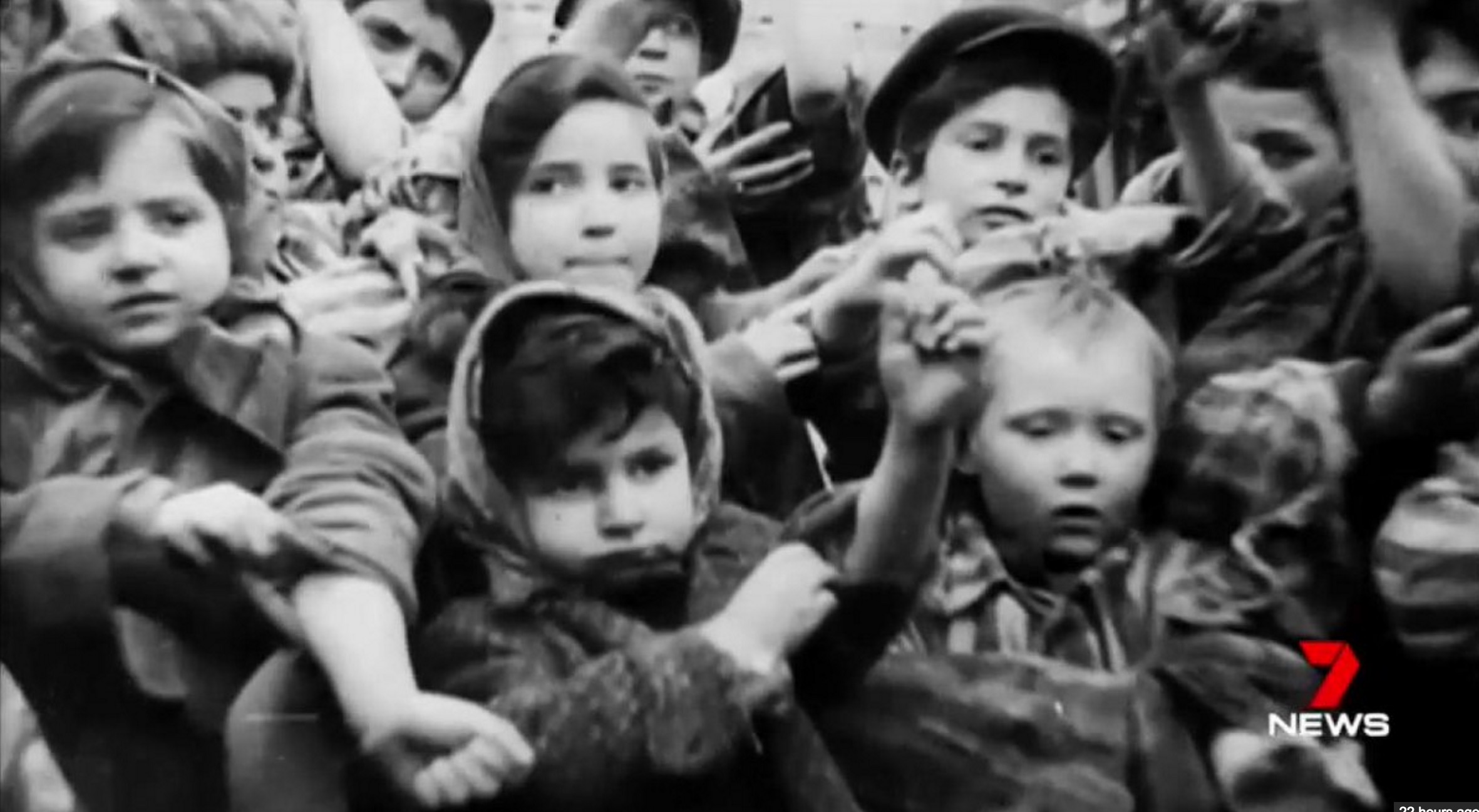 children being liberated from a camp all displaying their number tattoos