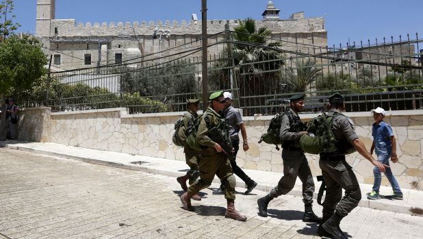 Soldiers walking in Hebron