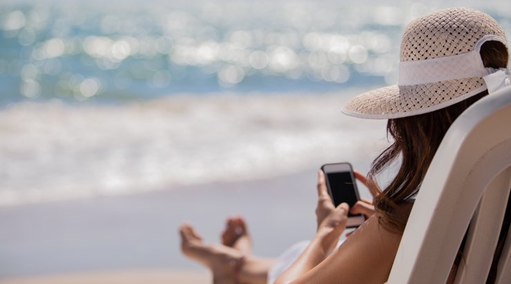 woman on phone at beach