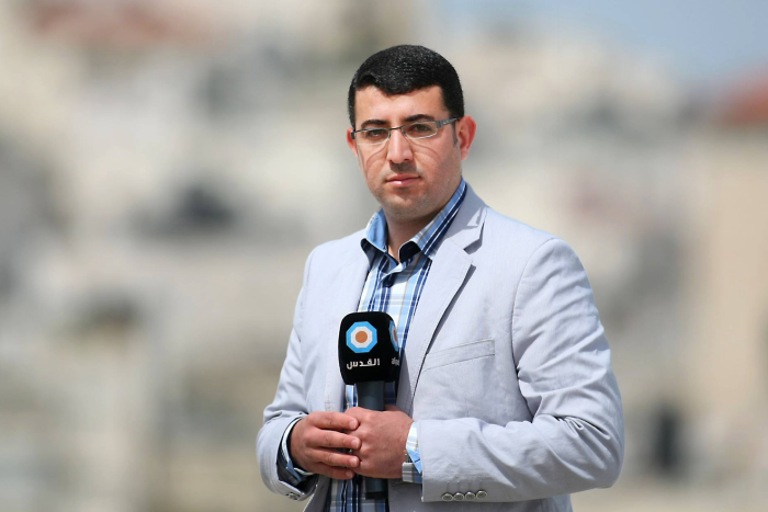 Mamdouh Hamamreh holding a microphone