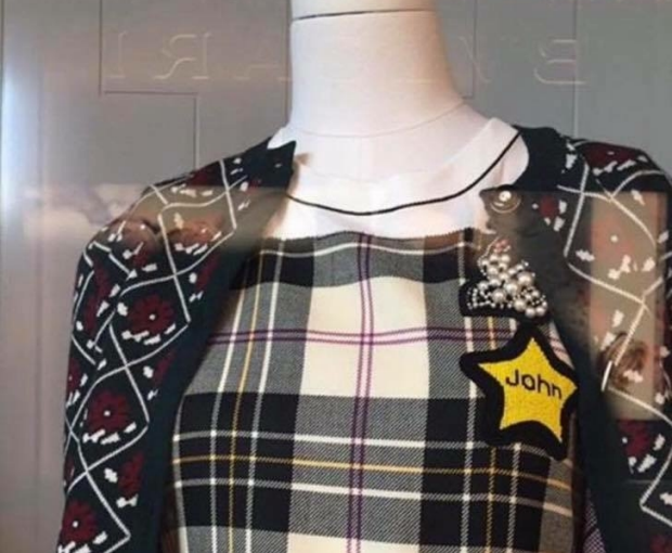 the dress on a mannequin, with the star that says John on it