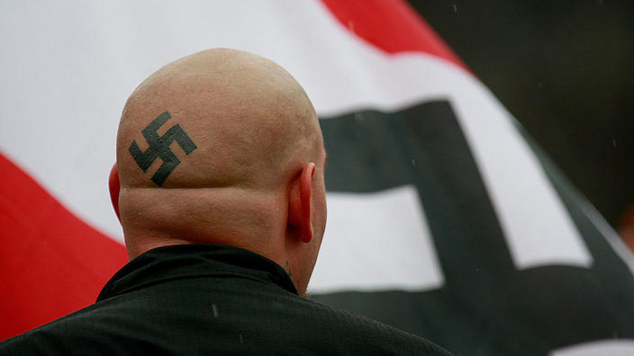 skinhead with swastika tattooed on bald head