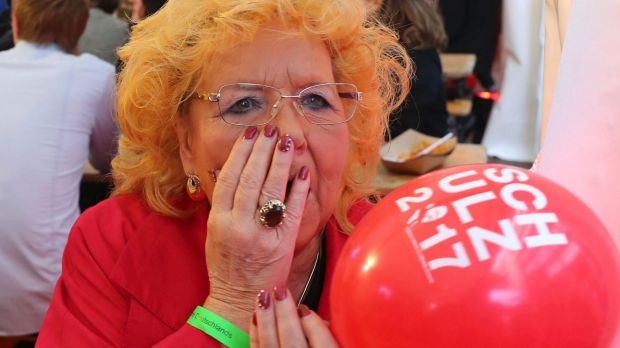 lady with hand over her mouth in shock at the election results