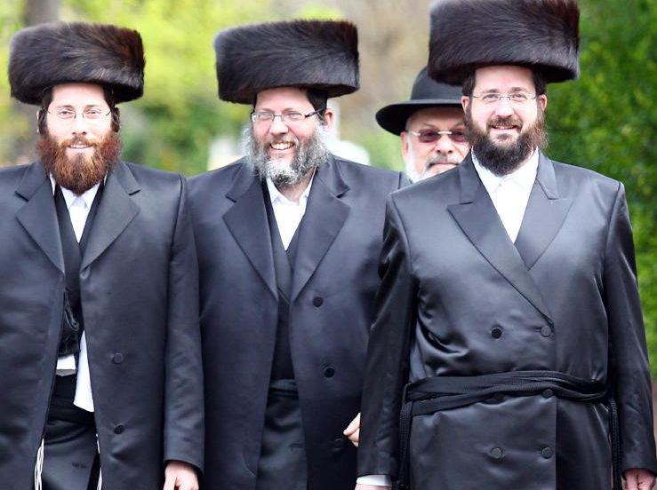 smiling ultra-orthodox men walking down the street