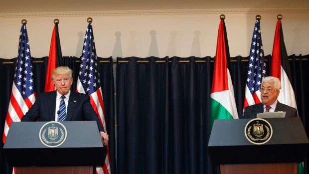 Trump and Abbas at podiums with flags behind them