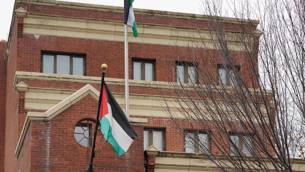 exterior of office with Palestinian flag flying