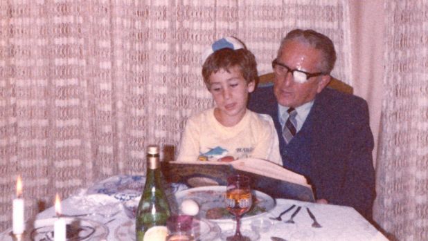 Bram as a young boy sitting on his grandfather's knee at the table