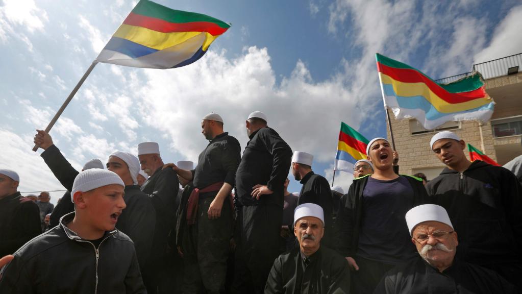Druze men protesting, flying flags