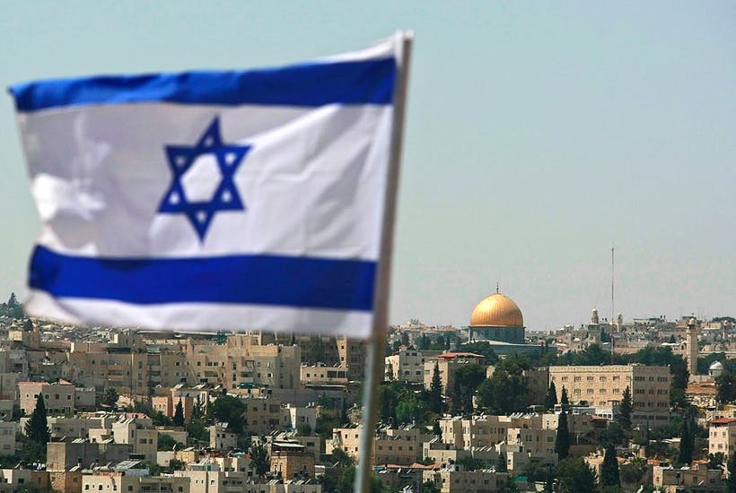 Jerusalem flag flying in foreground with dome of the rock in the background