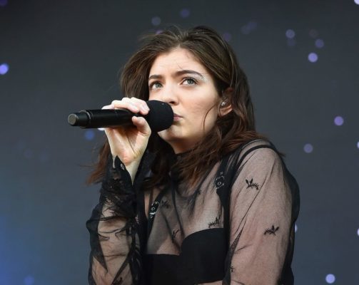 Lorde sitting microhpone at her mouth