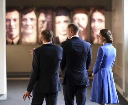 william and kate and other with backs to camera, looking at the holocaust exhibition