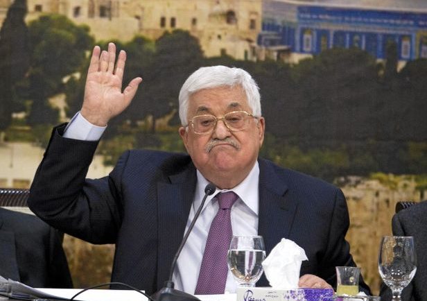 Abbas with hand in his air, during meeting