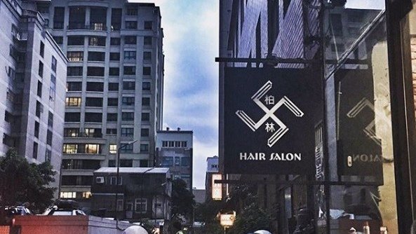 the swastika sign hanging outside the salon