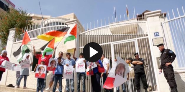 still from the video, protesters holding signs and flags