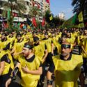 Thousands of Hezbollah supporters march in the streets of Beirut
